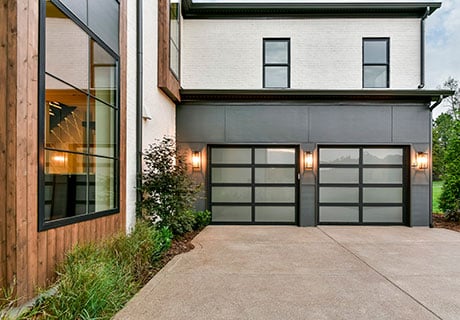 modern looking home with two garage doors