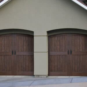 front view of house with wooden garage doors