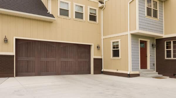front view of house with wooden garage doors