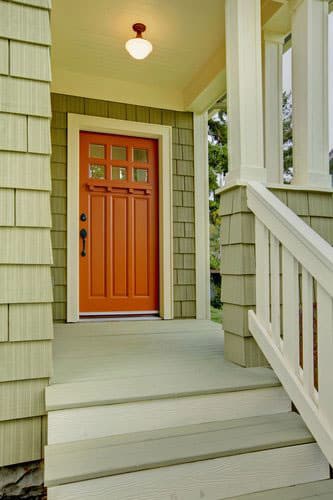 front porch with wooden door and light