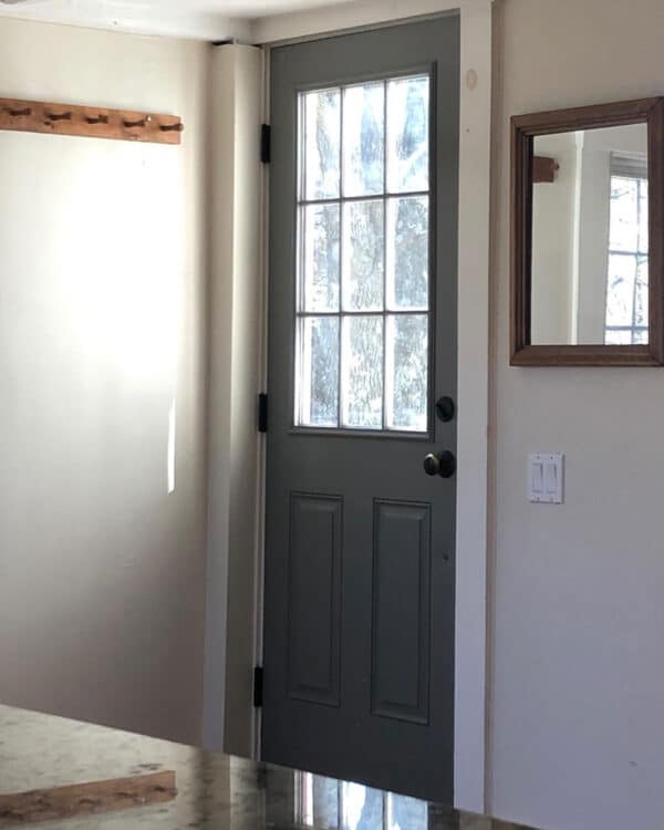 dark gray door with glass panel