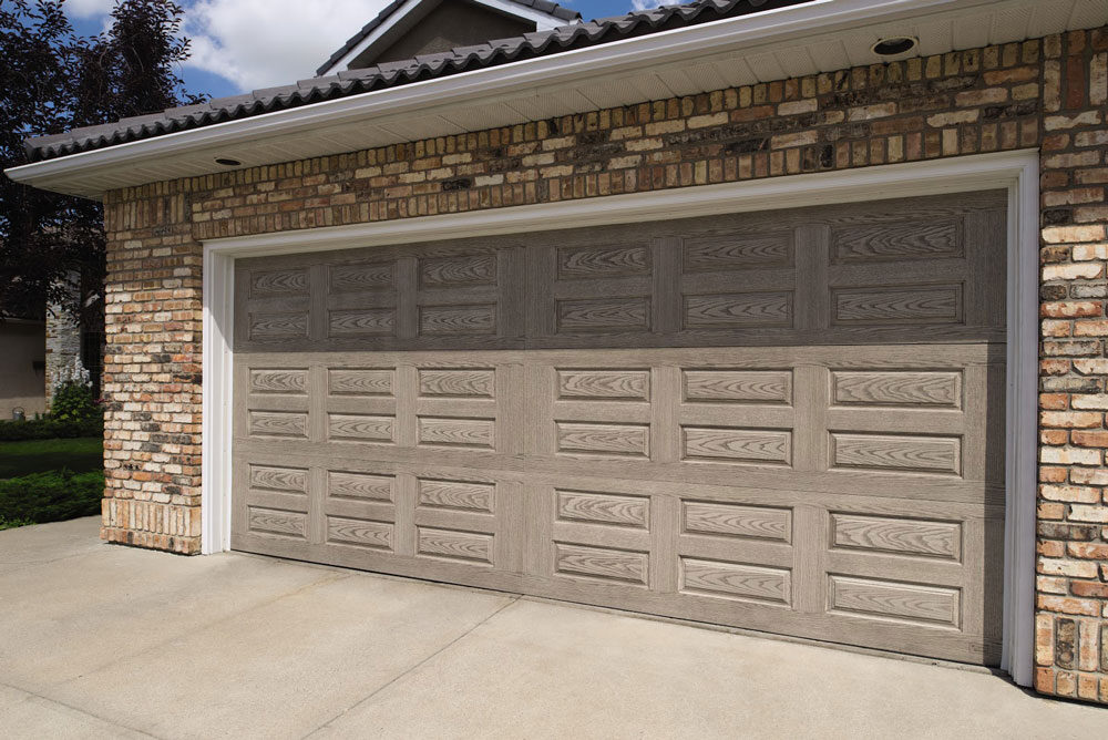 brick garage with horizontal raised panel garage door