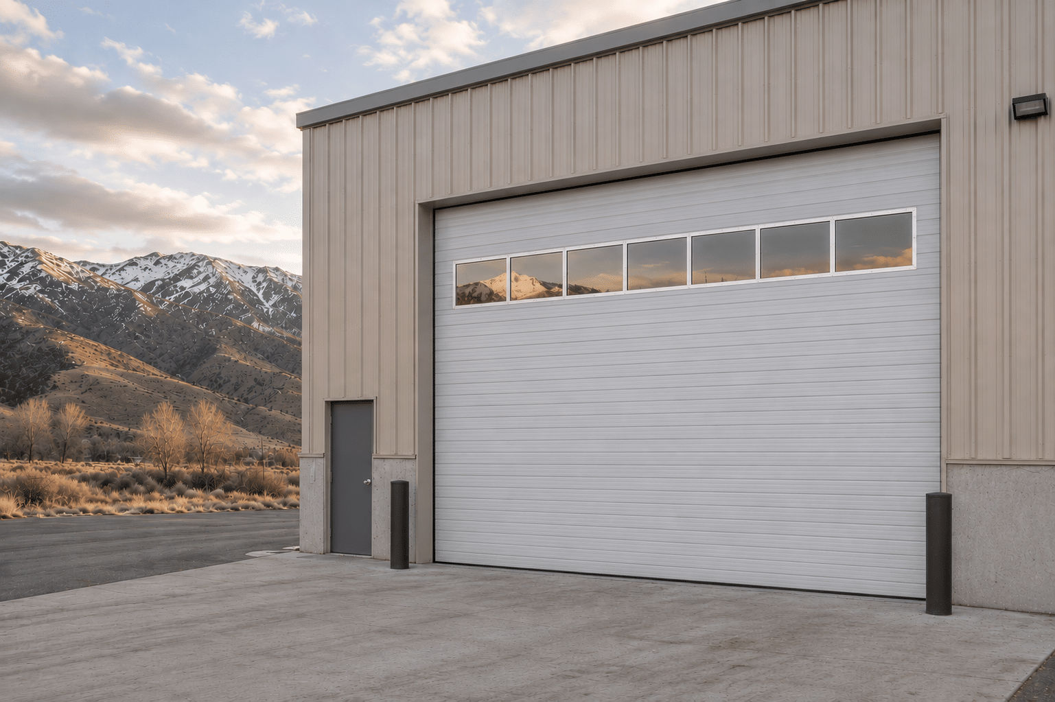 Newly installed insulated commercial sectional garage door on a warehouse in Utah